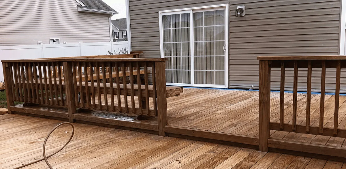 Deck sealing service protecting a backyard wood deck and railings in Seattle, WA