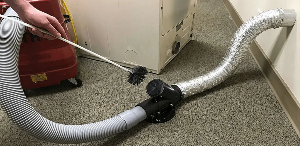 Dryer vent cleaning service removing lint from a dryer duct connection in Seattle, WA