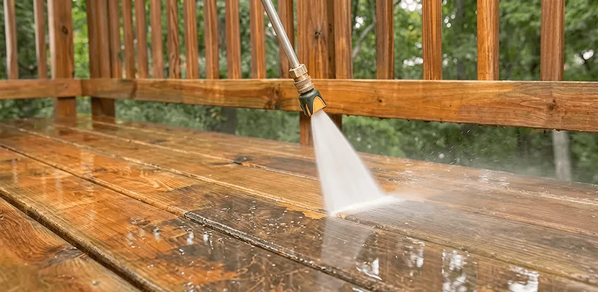 Pressure washing a wood deck to remove dirt and buildup in Seattle, WA